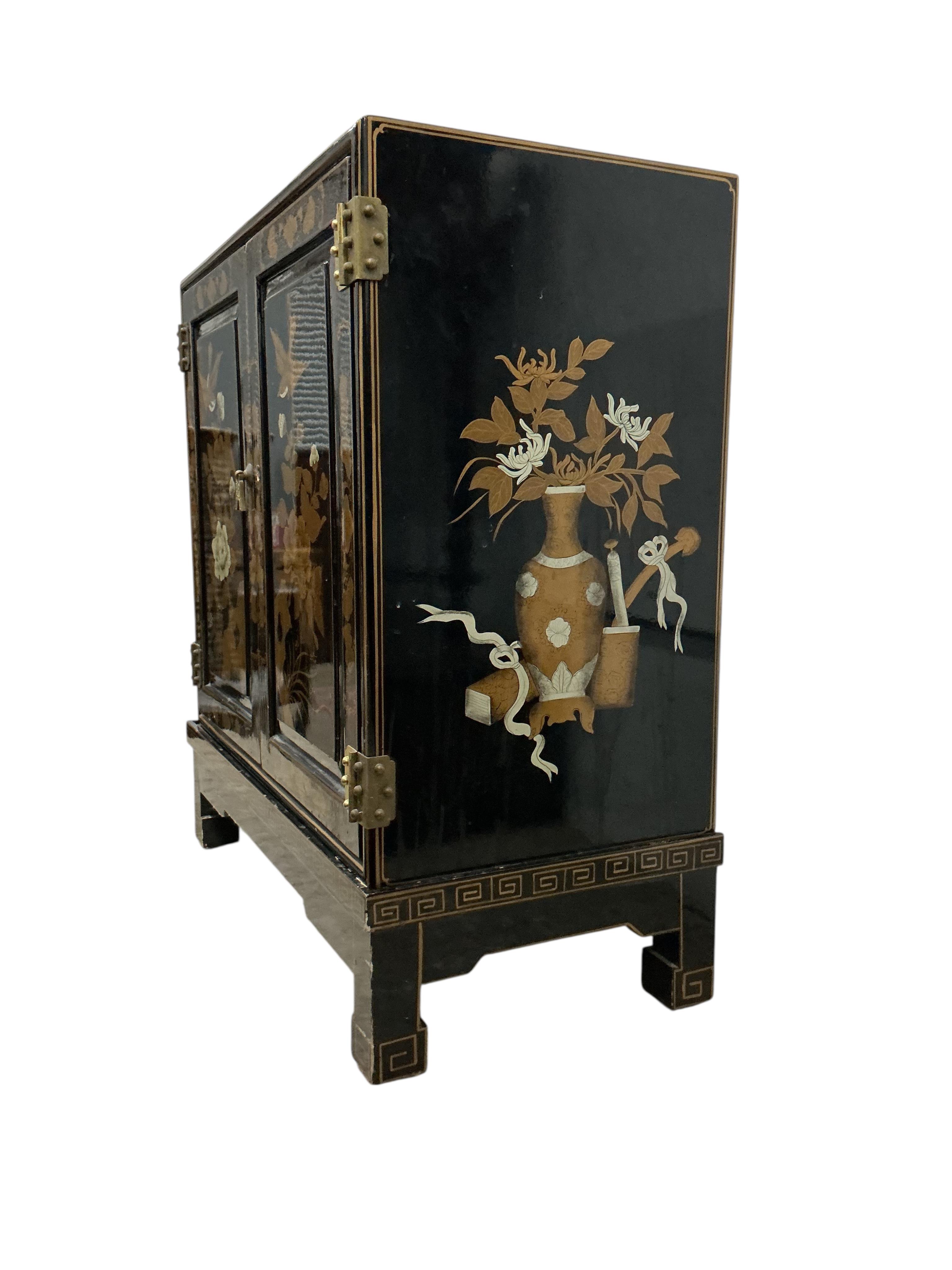 A small Chinese lacquered side cabinet, width 61cm, depth 30cm, height 67cm